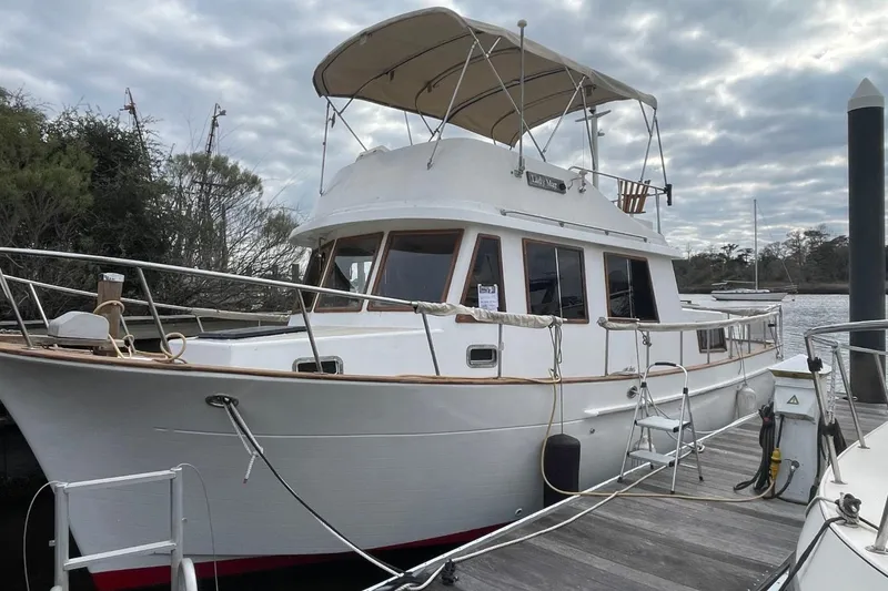 The Image of 1991 Marine Trader 34 Double Cabin yacht docked under cloudy skies. - 0