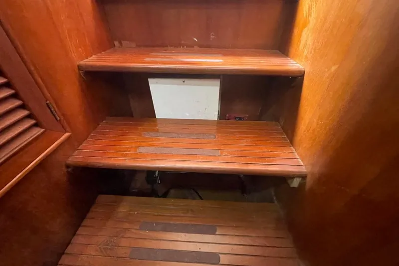 Slide: The Image of Wooden steps inside a 1991 Marine Trader 34 Double Cabin boat. - 11