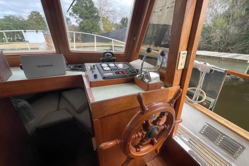 Slide: The Image of 1991 Marine Trader 34 Double Cabin helm with wooden wheel and navigation equipment. - 12