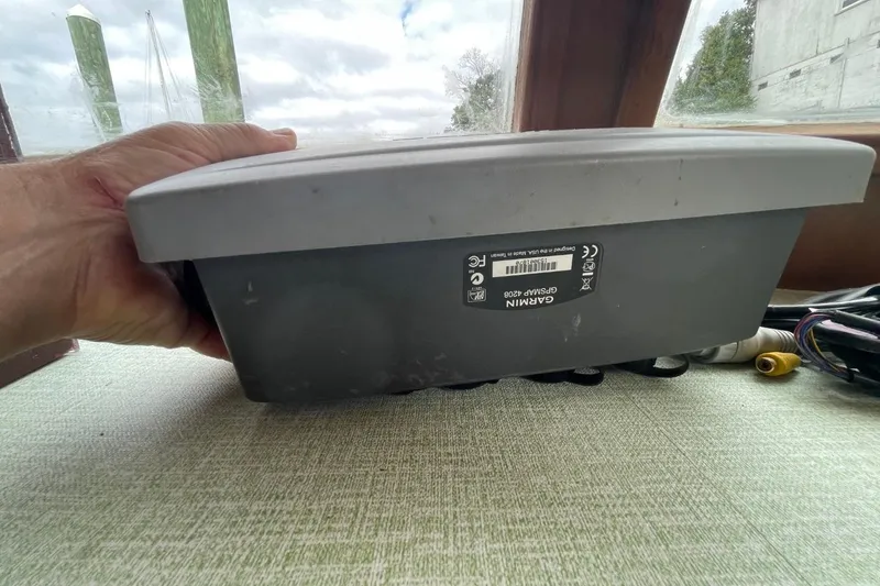 Slide: The Image of Hand holding Garmin GPSMAP 4208 device inside a 1991 Marine Trader 34 Double Cabin boat. - 15