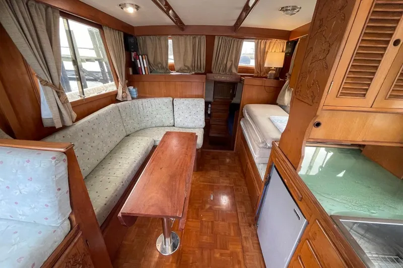 Slide: The Image of Interior of 1991 Marine Trader 34 Double Cabin with cozy seating and wooden finishes. - 21