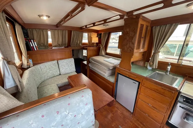 Slide: The Image of Interior of 1991 Marine Trader 34 Double Cabin with wood finish and compact kitchen. - 22