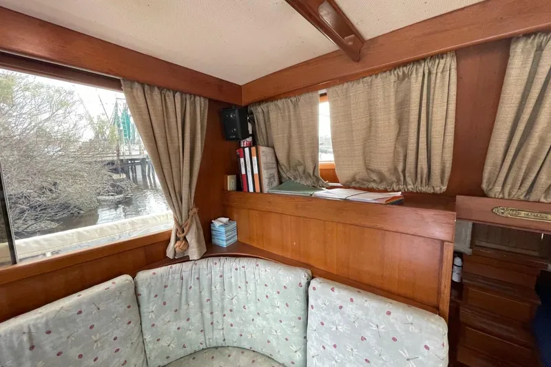 Slide: The Image of Interior of 1991 Marine Trader 34 Double Cabin with cozy seating and wooden accents. - 25