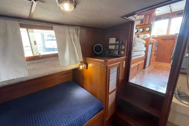 Slide: The Image of 1991 Marine Trader 34 Double Cabin interior with cozy wooden furnishings and nautical decor. - 34