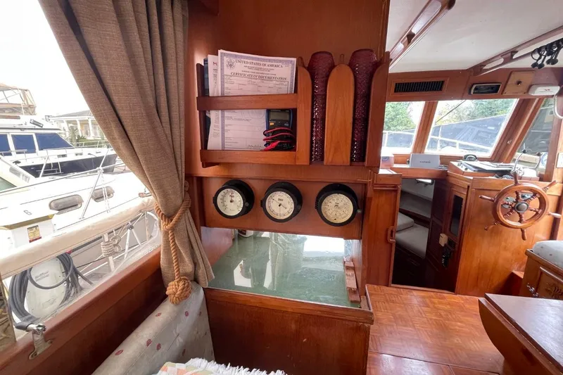 Slide: The Image of 1991 Marine Trader 34 Double Cabin interior with gauges and wooden helm. - 35