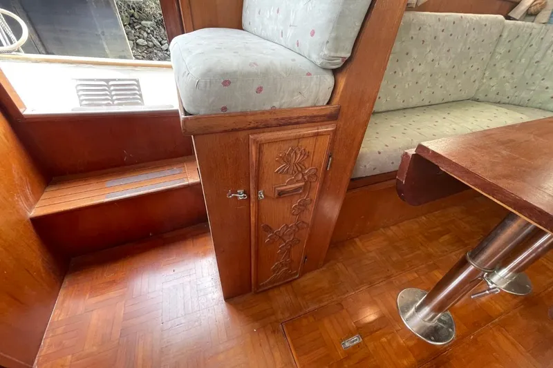 Slide: The Image of 1991 Marine Trader 34 Double Cabin interior with wood finish and floral cabinet design. - 36