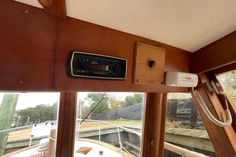 Slide: The Image of 1991 Marine Trader 34 Double Cabin interior with depth gauge and communication equipment. - 38