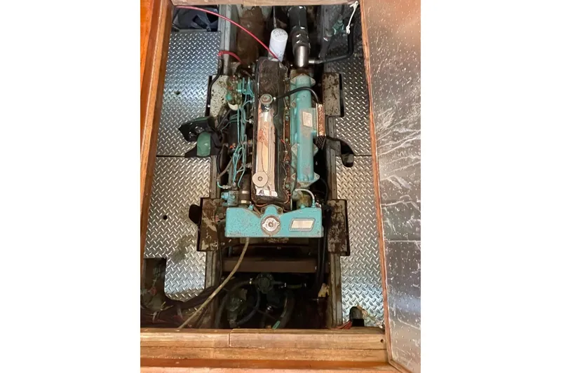 Slide: The Image of 1991 Marine Trader 34 Double Cabin engine compartment with visible machinery and metal flooring. - 40