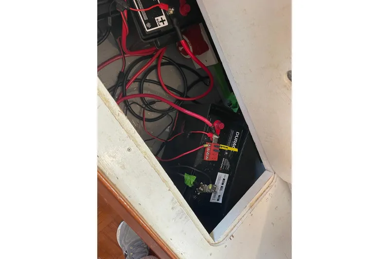 Slide: The Image of Battery compartment of a 1991 Marine Trader 34 Double Cabin with visible wiring. - 41