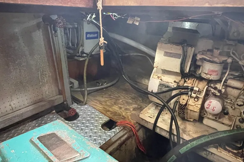 Slide: The Image of Engine room of a 1991 Marine Trader 34 Double Cabin boat, showing machinery and wiring. - 43