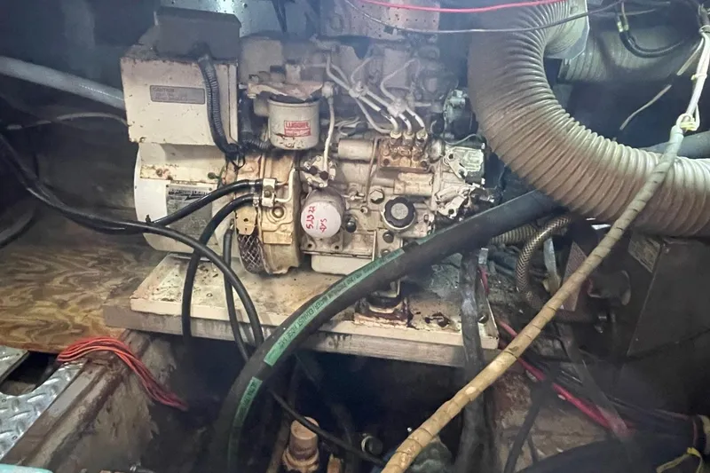 Slide: The Image of Engine compartment of a 1991 Marine Trader 34 Double Cabin boat, showing mechanical components. - 44