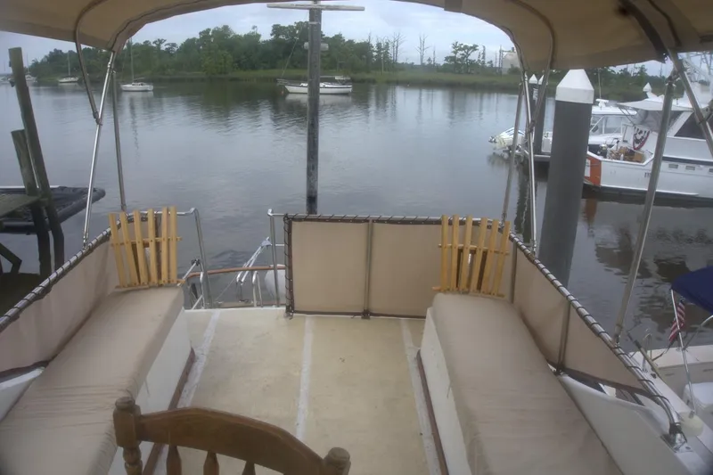 Slide: The Image of 1991 Marine Trader 34 Double Cabin boat deck with river view and moored boats. - 64