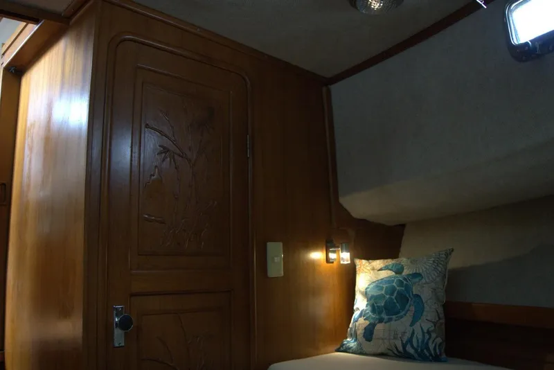 Slide: The Image of Interior of 1991 Marine Trader 34 Double Cabin with wooden door and turtle-themed pillow. - 67