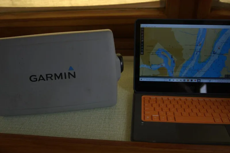 Slide: The Image of Garmin device and laptop with nautical map on Marine Trader 34 Double Cabin, 1991. - 69