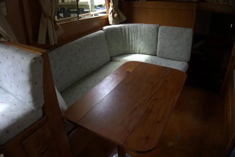 Slide: The Image of Interior of 1991 Marine Trader 34 Double Cabin with cozy seating and wooden table. - 73