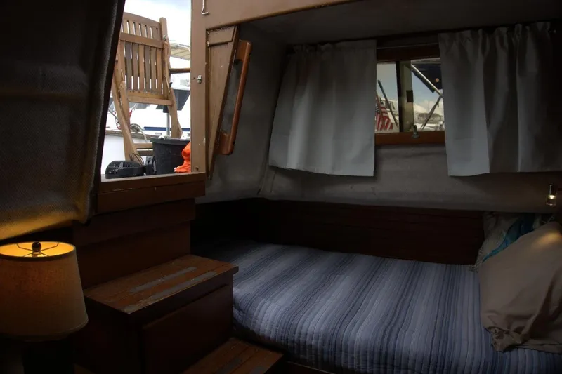 Slide: The Image of Interior of 1991 Marine Trader 34 Double Cabin with cozy bed and window view. - 75