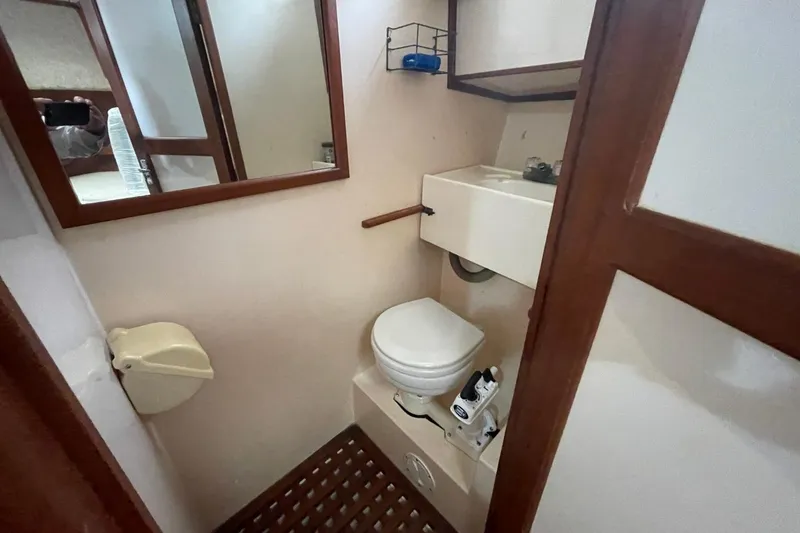 Slide: The Image of Bathroom interior of 1991 Marine Trader 34 Double Cabin yacht, featuring toilet and sink. - 8
