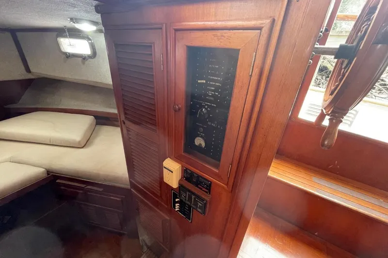 Slide: The Image of 1991 Marine Trader 34 Double Cabin interior with control panel and cozy sleeping area. - 9