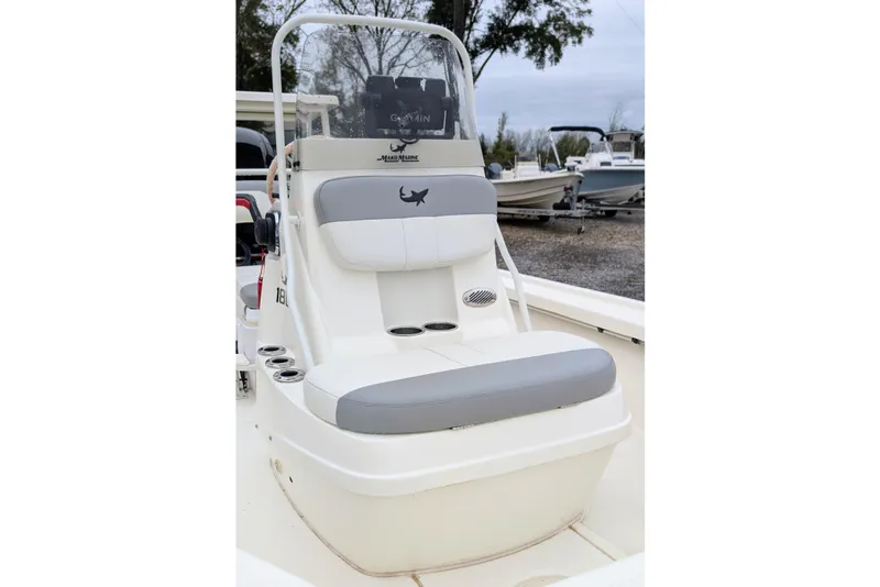 Slide: The Image of 2023 Mako 18 LTS boat interior with cushioned seating and console. - 7
