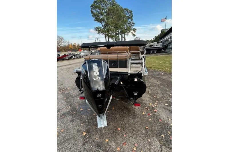 Slide: The Image of 2025 Regency 230 LE3 Sport boat with powerful Mercury V8 engine, parked outdoors. - 2