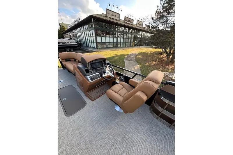 Slide: The Image of 2025 Regency 230 LE3 Sport boat interior with luxurious seating and modern dashboard. - 9