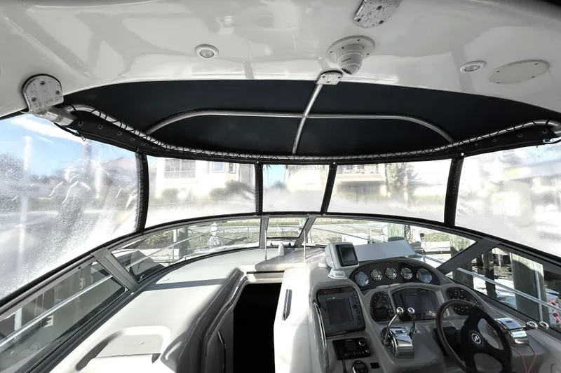 Slide: The Image of Interior view of 2006 Sea Ray 320 Sundancer boat cockpit with navigation controls. - 11