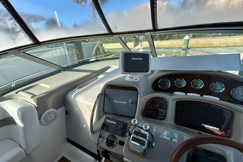 Slide: The Image of 2006 Sea Ray 320 Sundancer helm with Raymarine navigation system and gauges. - 13
