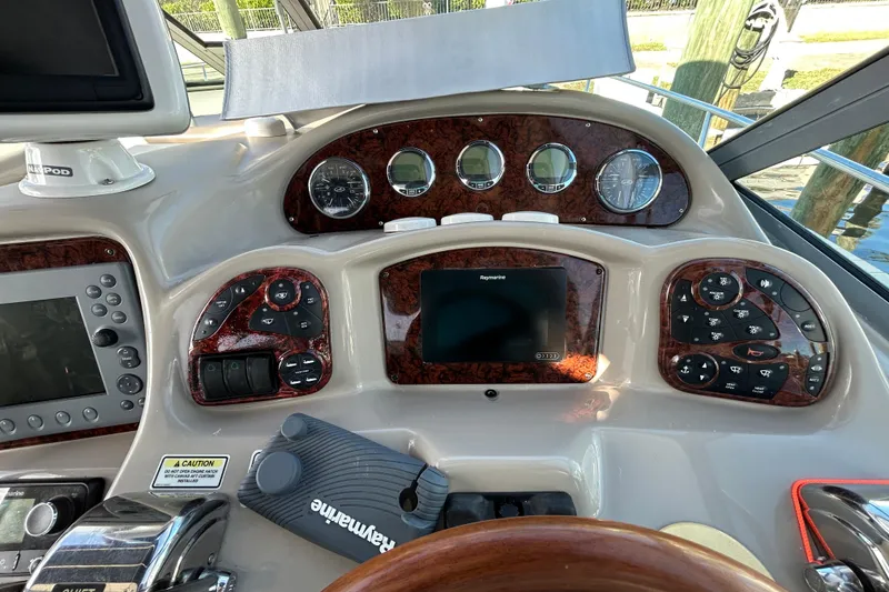 Slide: The Image of Helm of 2006 Sea Ray 320 Sundancer with navigation controls and gauges. - 19
