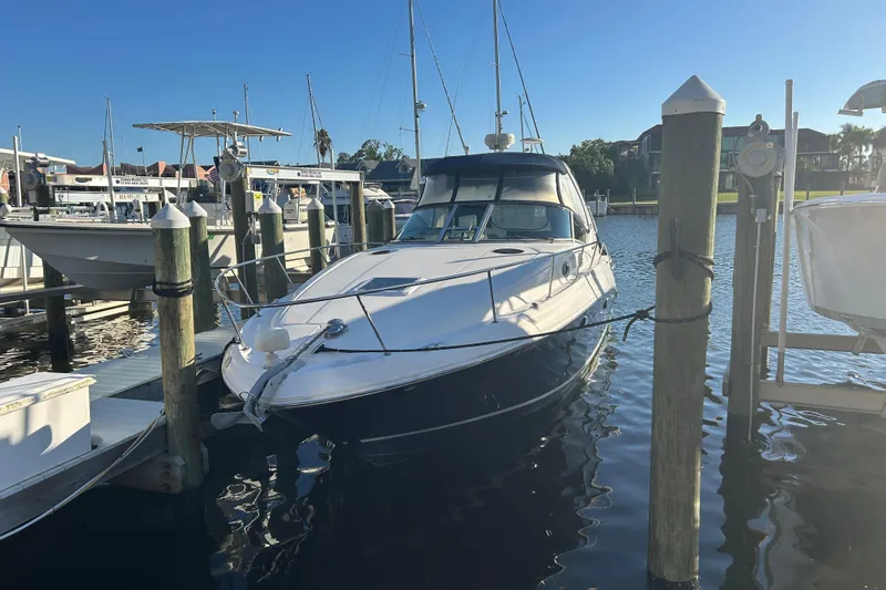 Slide: The Image of 2006 Sea Ray 320 Sundancer docked at marina under clear blue sky. - 2
