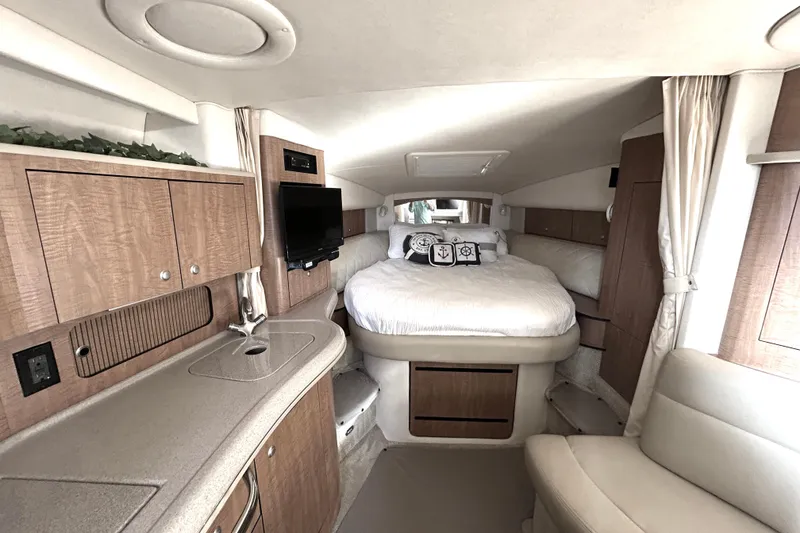Slide: The Image of Luxurious interior of 2006 Sea Ray 320 Sundancer yacht with cozy bed and modern amenities. - 24