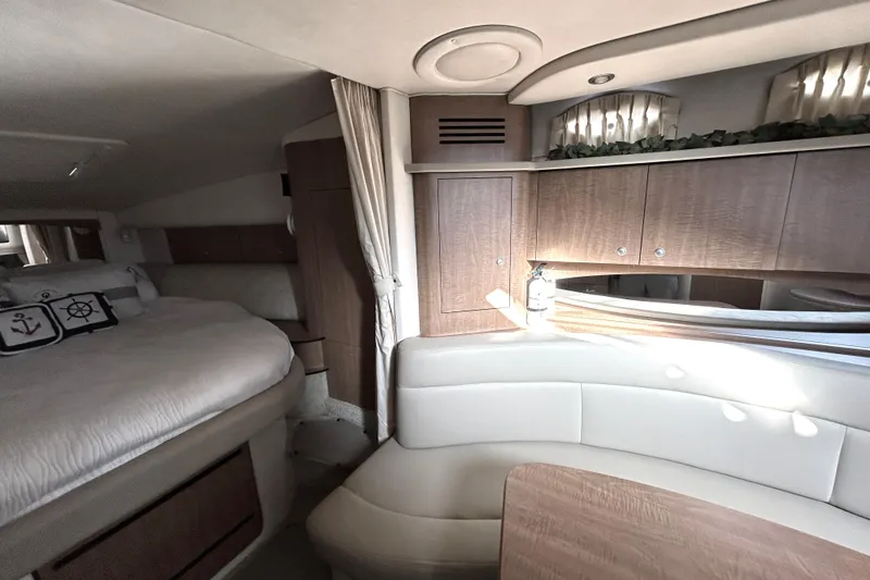 Slide: The Image of Interior of 2006 Sea Ray 320 Sundancer with cozy bed and seating area. - 25