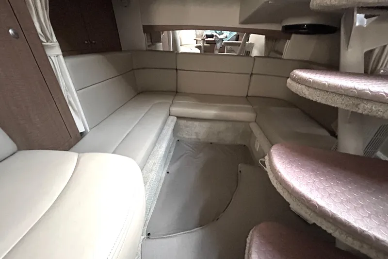 Slide: The Image of Interior of 2006 Sea Ray 320 Sundancer yacht with beige seating and carpeted steps. - 28