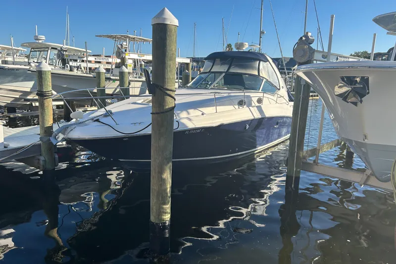 Slide: The Image of 2006 Sea Ray 320 Sundancer docked at marina under clear blue sky. - 3