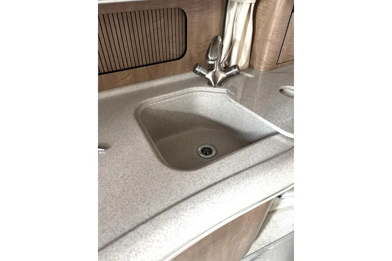 Slide: The Image of 2006 Sea Ray 320 Sundancer interior sink with modern faucet and countertop. - 30