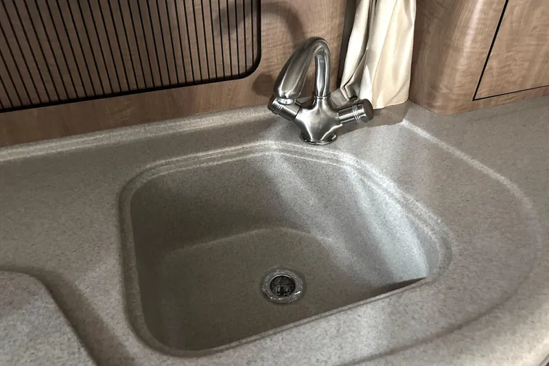 Slide: The Image of Kitchen sink and faucet in 2006 Sea Ray 320 Sundancer boat interior. - 31