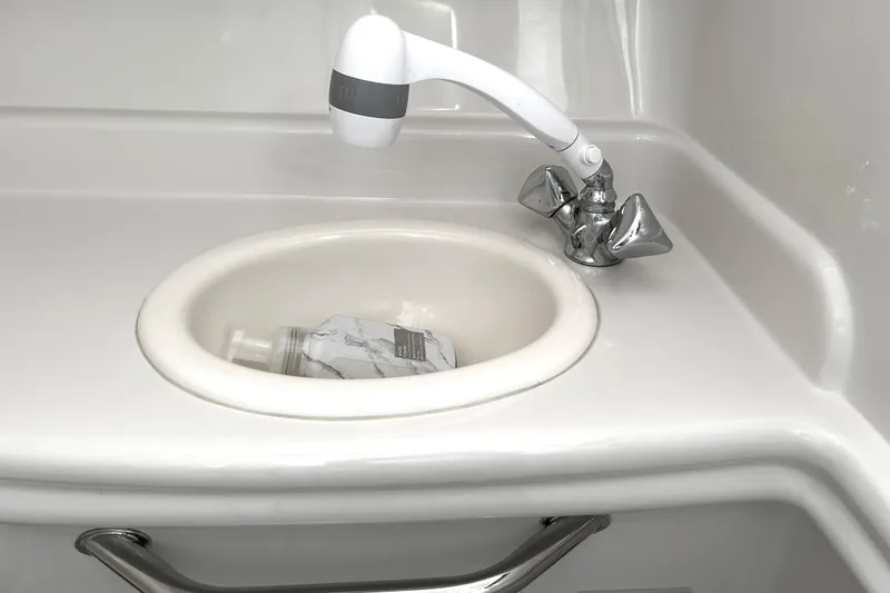 Slide: The Image of White sink and faucet in 2006 Sea Ray 320 Sundancer boat bathroom. - 38