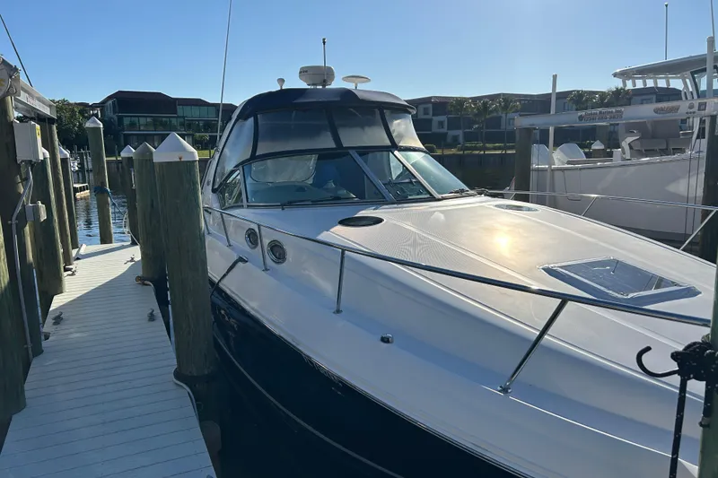 Slide: The Image of 2006 Sea Ray 320 Sundancer docked at marina under clear sky. - 4
