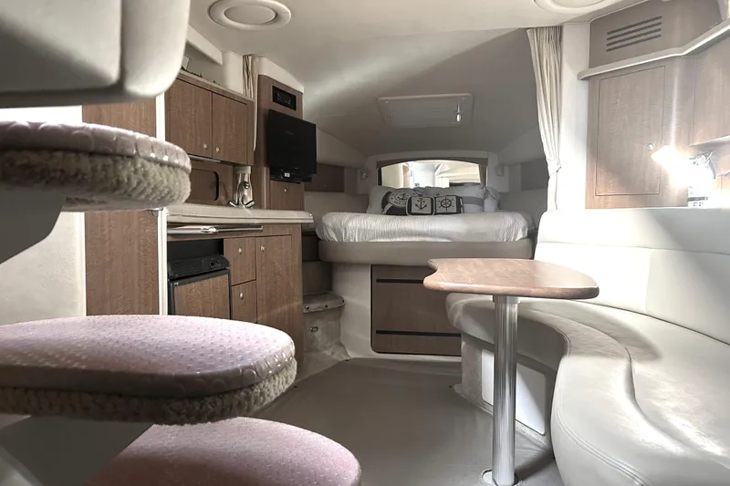 Slide: The Image of Interior of 2006 Sea Ray 320 Sundancer yacht with cozy seating and bed. - 40