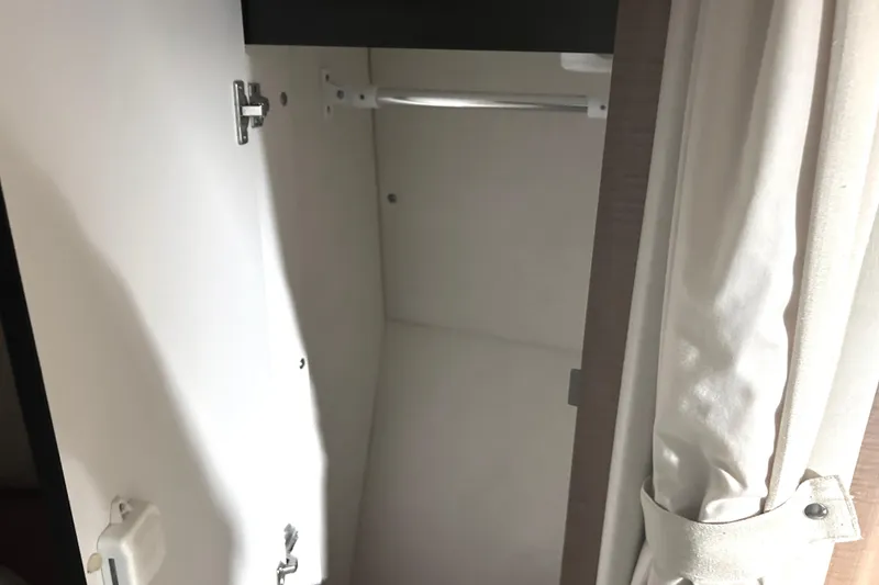 Slide: The Image of Open closet inside 2006 Sea Ray 320 Sundancer boat, featuring a hanging rod and curtain. - 41