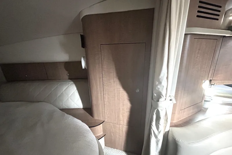 Slide: The Image of Interior cabin of 2006 Sea Ray 320 Sundancer with wood paneling and cozy seating. - 42