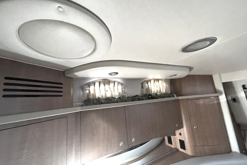 Slide: The Image of Interior of 2006 Sea Ray 320 Sundancer with wood cabinets and decorative accents. - 43