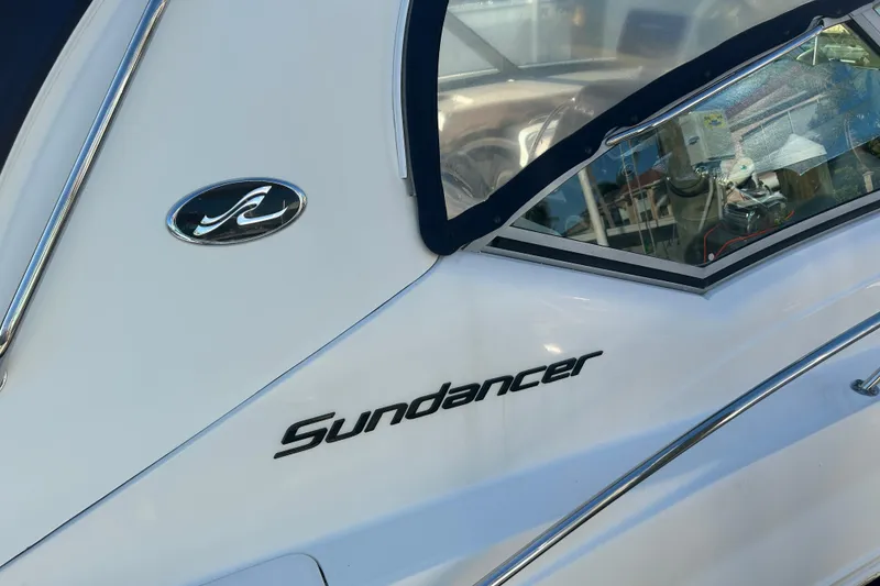 Slide: The Image of 2006 Sea Ray 320 Sundancer boat, close-up of logo and window detail. - 44