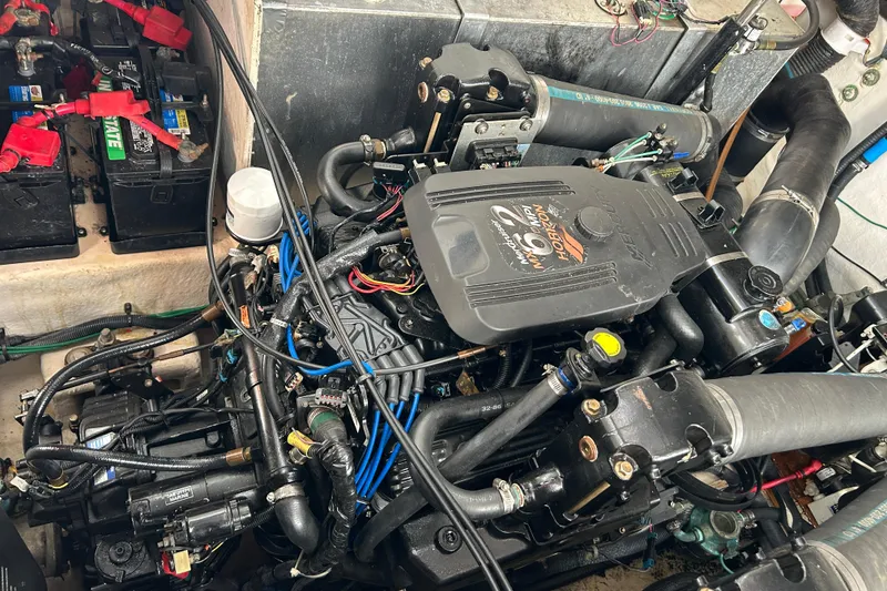 Slide: The Image of Engine compartment of a 2006 Sea Ray 320 Sundancer with visible batteries and wiring. - 48