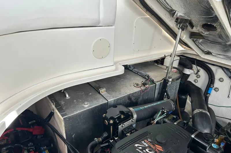 Slide: The Image of Engine compartment of a 2006 Sea Ray 320 Sundancer boat, showing mechanical components. - 49
