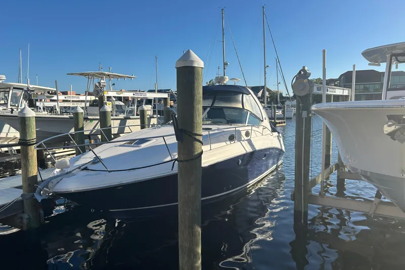 Slide: The Image of 2006 Sea Ray 320 Sundancer docked at marina under clear blue sky. - 5