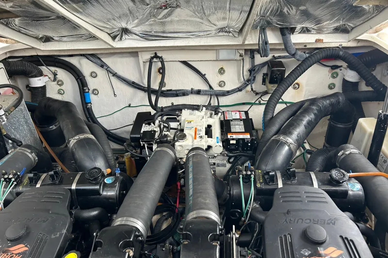 Slide: The Image of Engine compartment of a 2006 Sea Ray 320 Sundancer boat, showcasing mechanical components. - 50