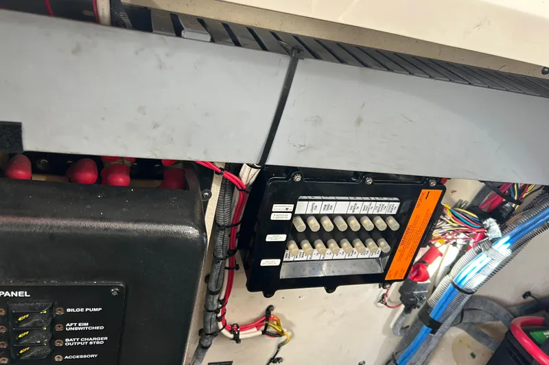 Slide: The Image of Electrical panel of a 2006 Sea Ray 320 Sundancer boat, showing wiring and switches. - 53