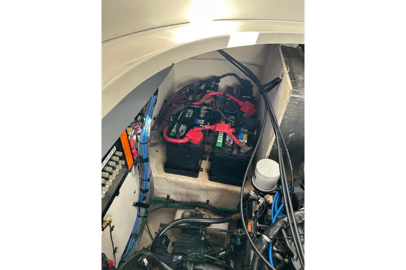 Slide: The Image of Engine compartment of 2006 Sea Ray 320 Sundancer with visible batteries and wiring. - 54