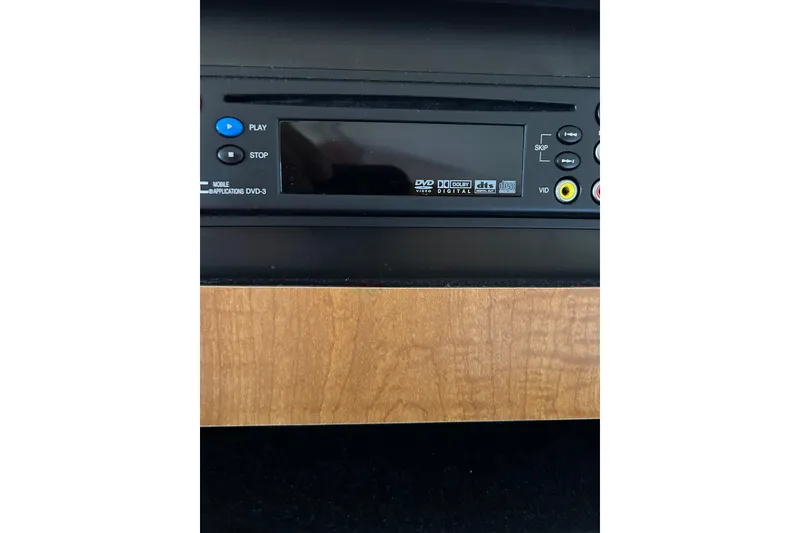 Slide: The Image of DVD player in 2006 Sea Ray 320 Sundancer boat, featuring play and stop buttons. - 58