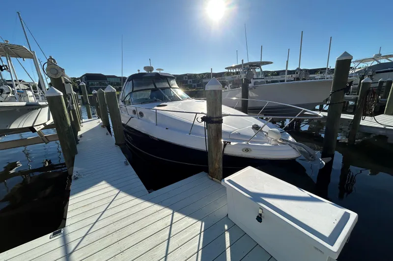 Slide: The Image of 2006 Sea Ray 320 Sundancer docked at marina under bright sunlight. - 6
